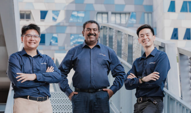 Three people smiling in a team collaboration.