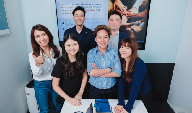 Diverse team of happy white-collar workers in office.