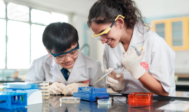 Two students in laboratory conducting research.